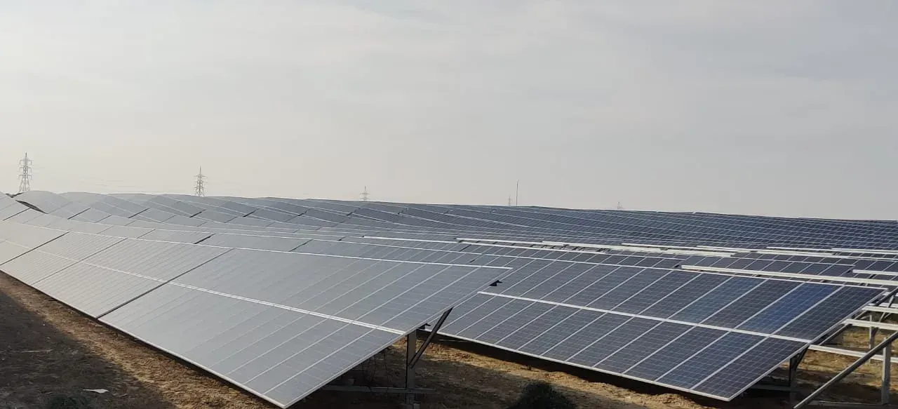 Rows of solar panels across flat desert land at the Bhadla solar park, Rajasthan